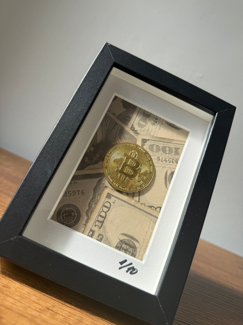 Close-up of object100™ Digital Gold Frame in black wooden frame