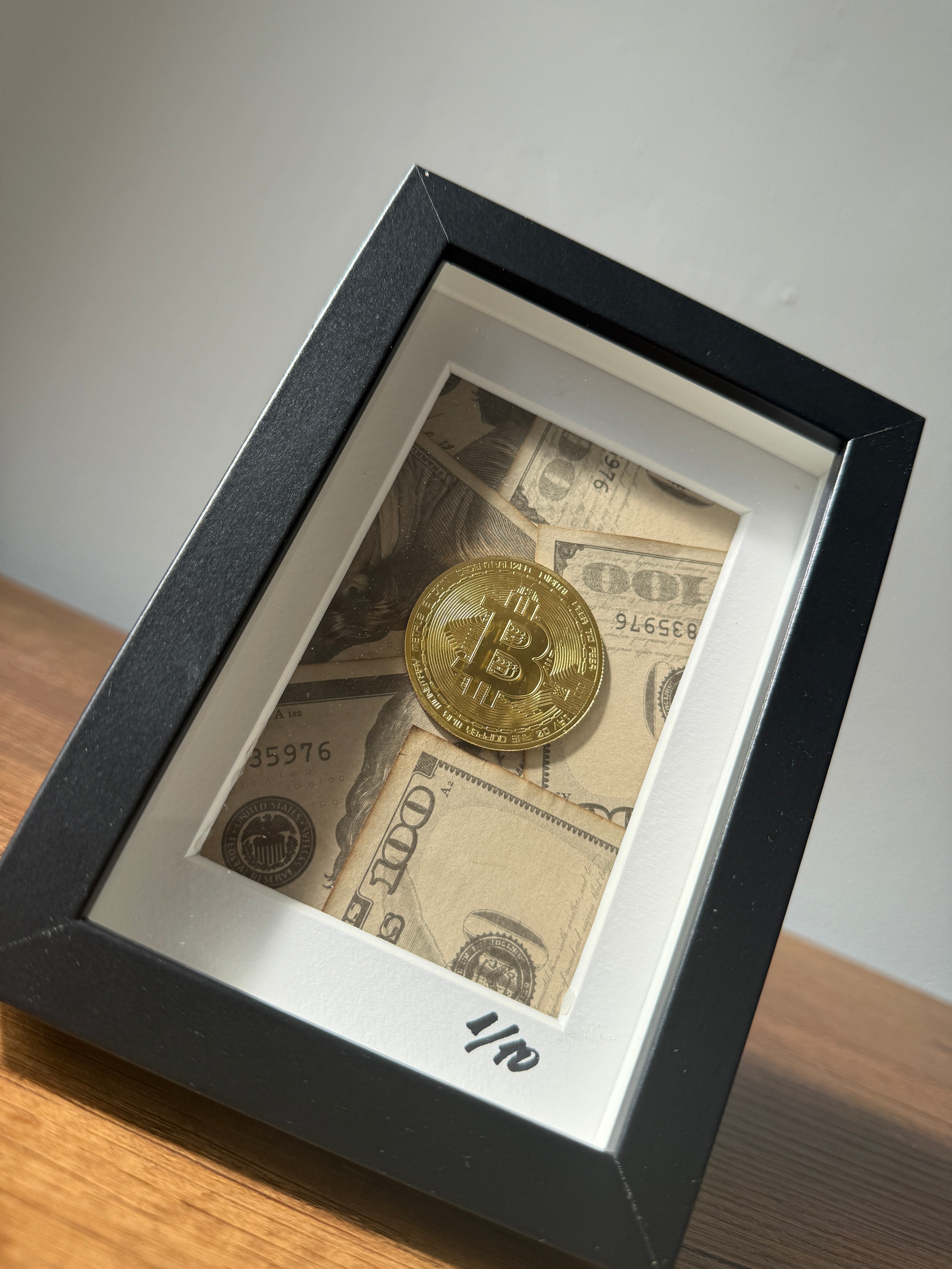 Close-up of object100™ Digital Gold Frame in black wooden frame