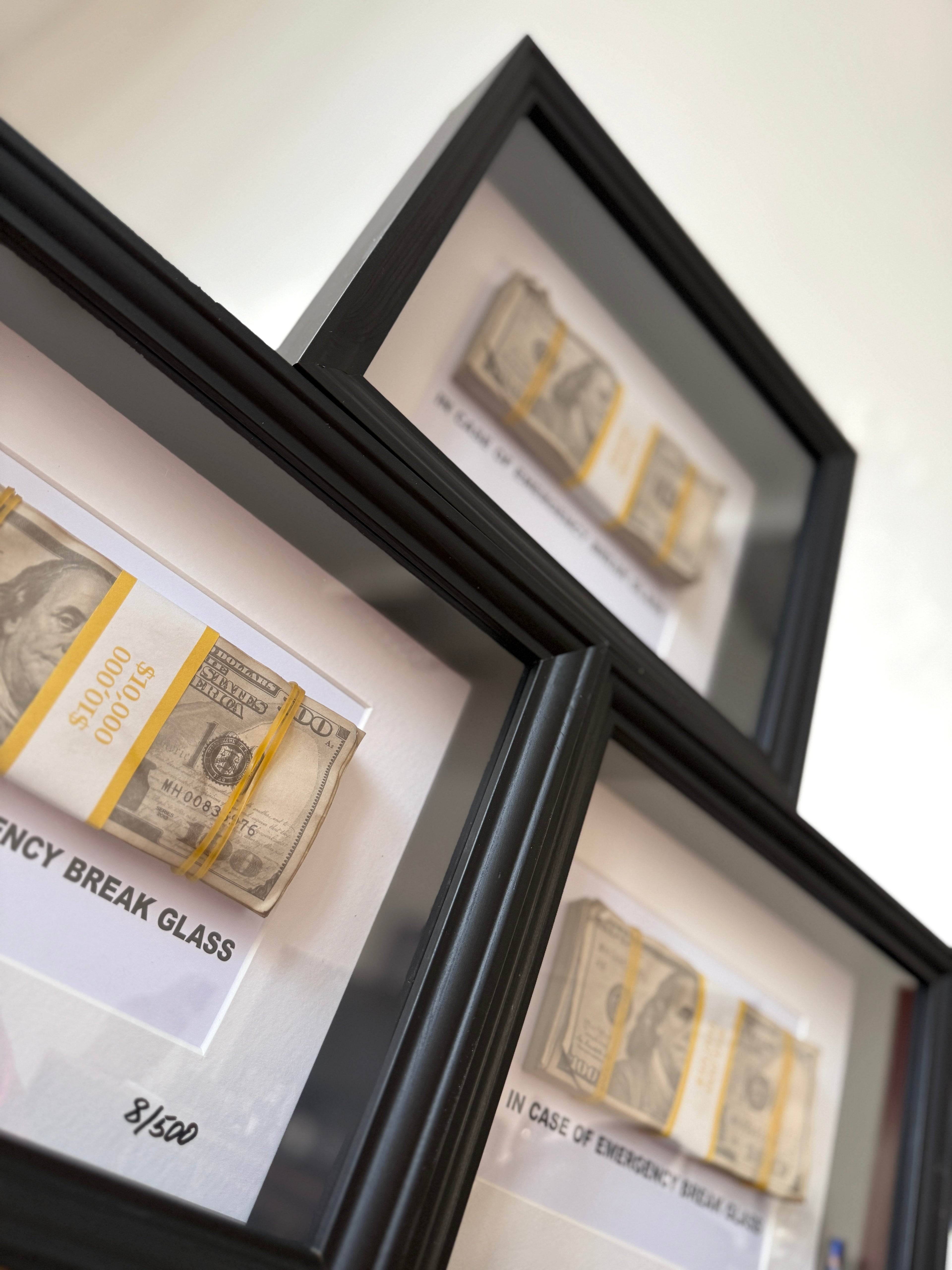 Angled view of object100™ Emergency €100 Frame in premium black wooden frame