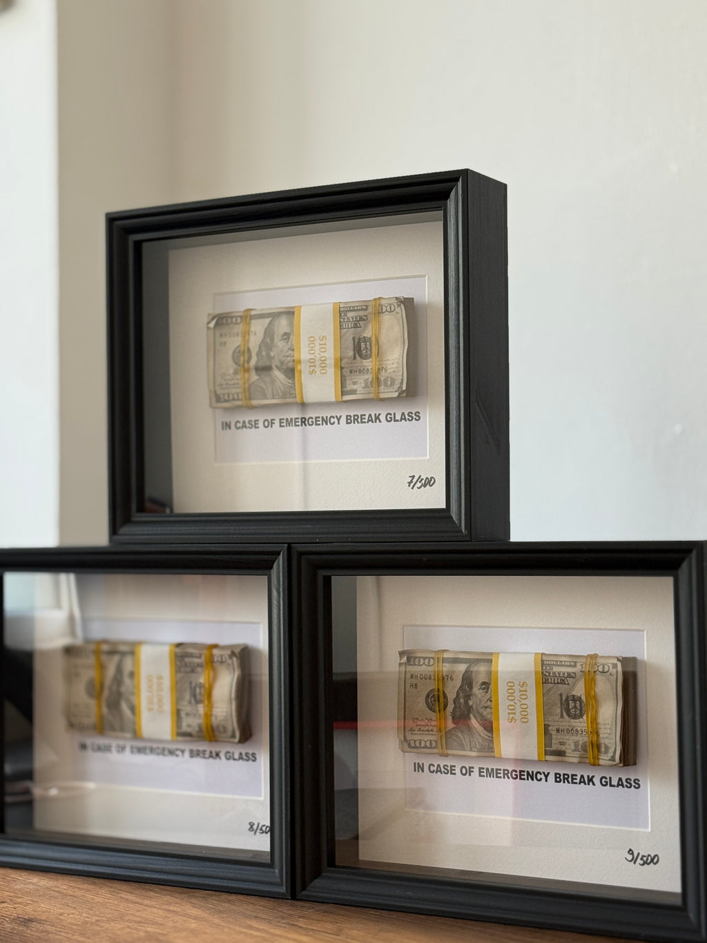 Close-up of object100™ Emergency €100 Frame with bundled dollar banknotes