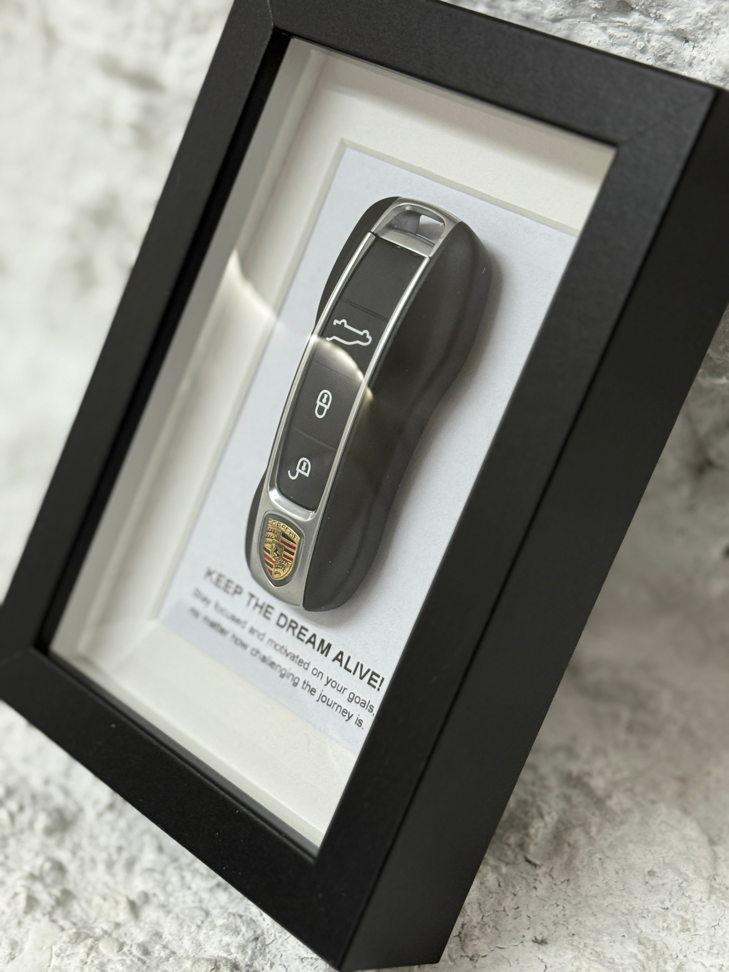 Close-up of object100™ Keep The Dream Alive in premium black wooden frame