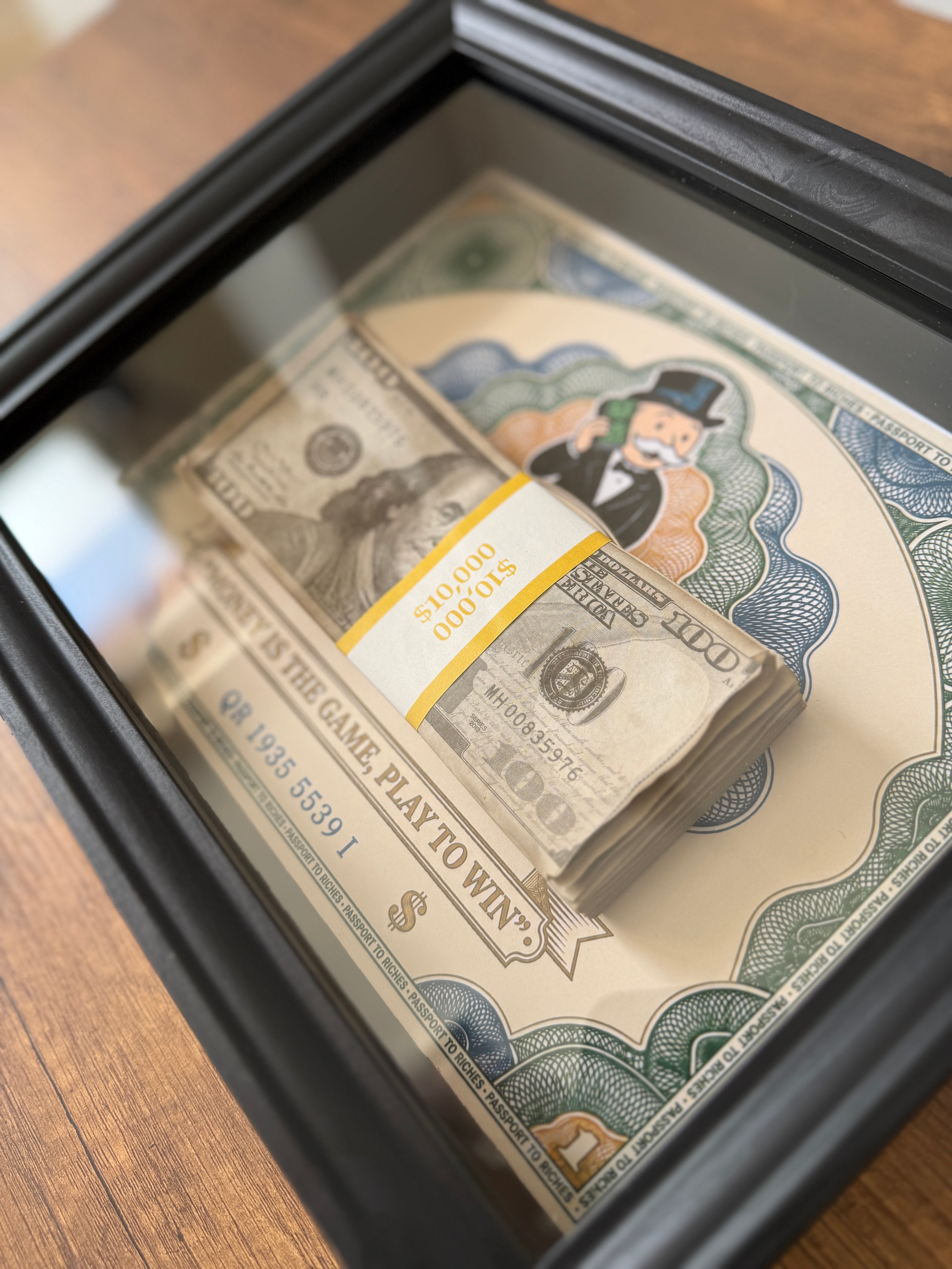 Close-up of OBJECT100™ Money Game Frame in premium black wooden frame